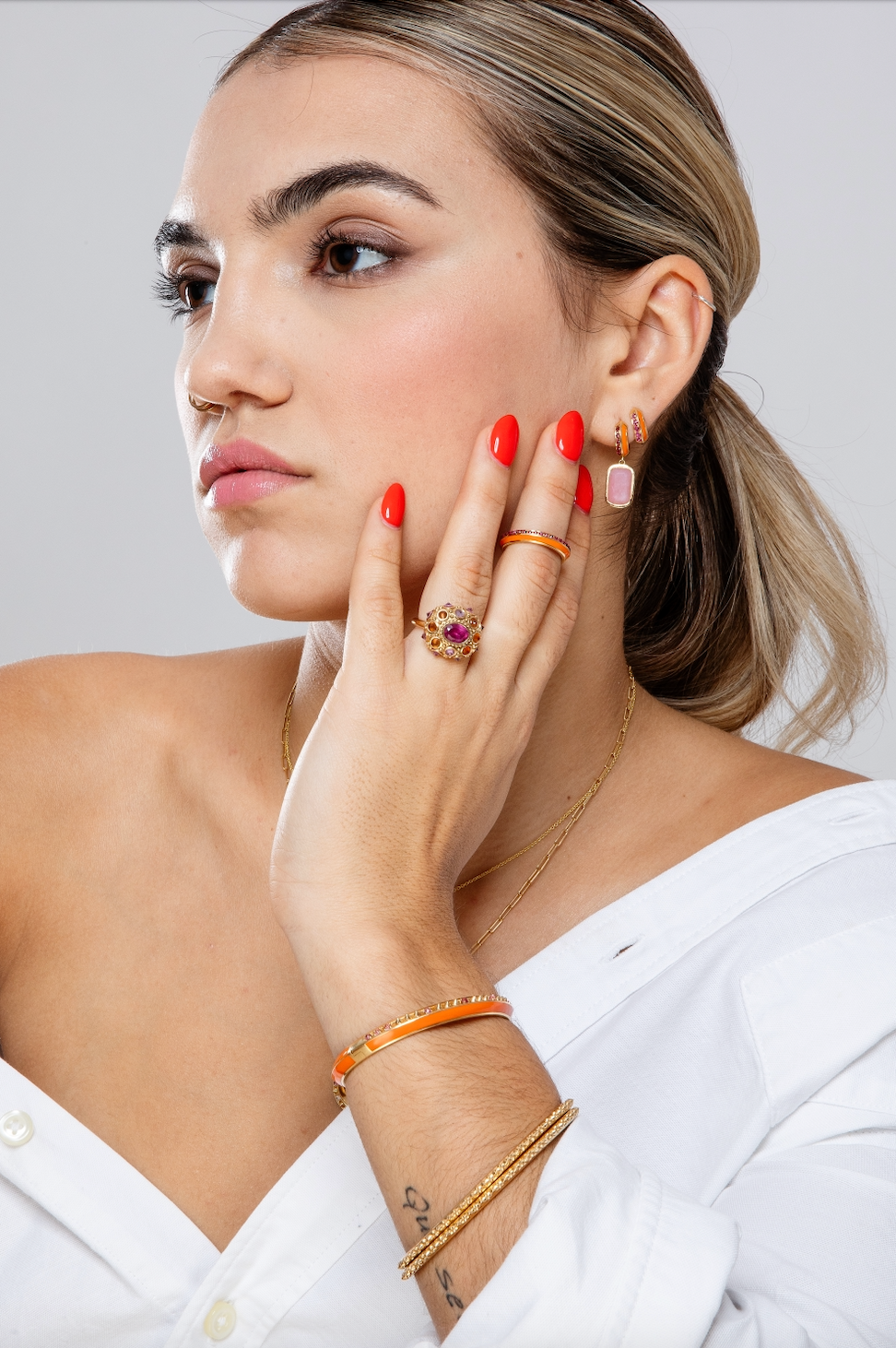 The Pink Tourmaline side view of AnaKatarina's 'Sweet, Happy Life' Pink Tourmaline Stacking Ring in 18k yellow gold ring adorned with the word "love" in gold, orange enamel, and .48tw Pink Tourmaline, exuding elegance and charm.