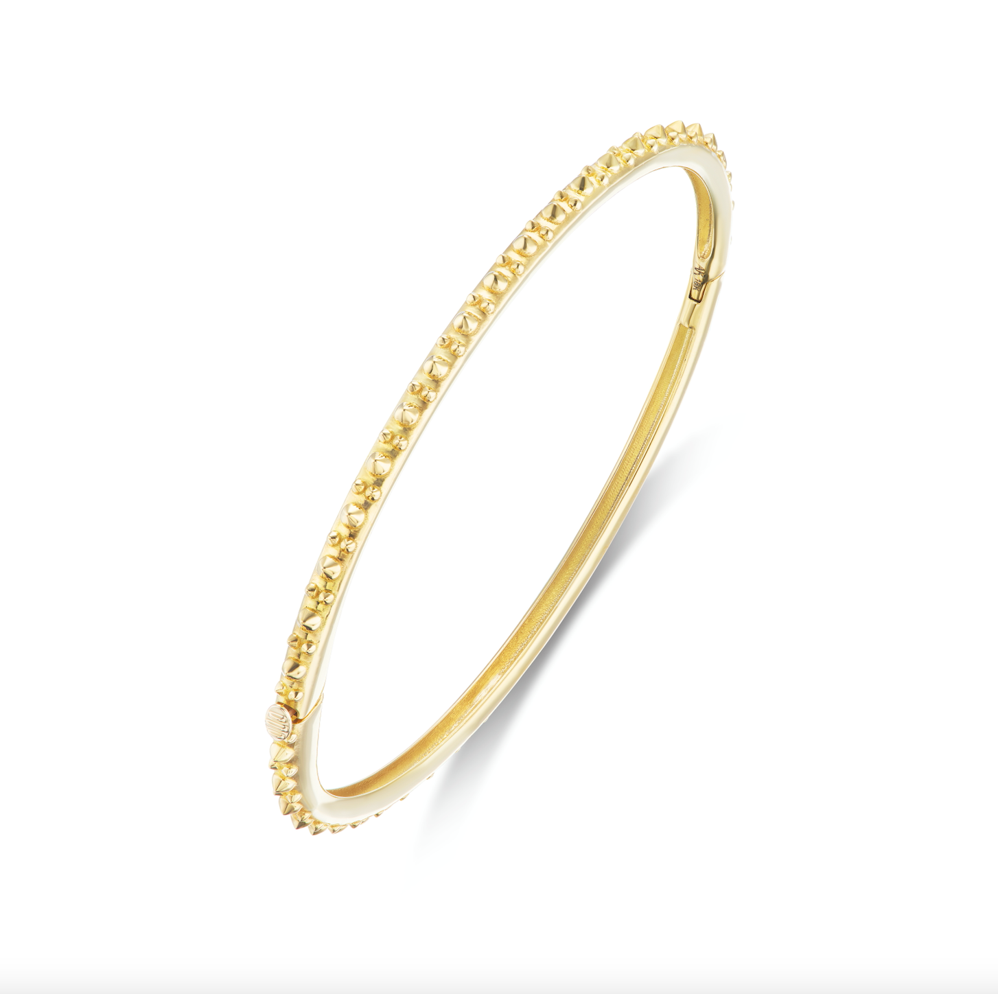 A perpendicular view of AnaKatarina's Attitude Yellow Gold 'Adrina Loves a Bangle' 18K yellow gold bangle. In her reinvention of the classic bangle, AK combines traditional form with a fusion of confidence and femininity, showcasing 18k gold spikes.
