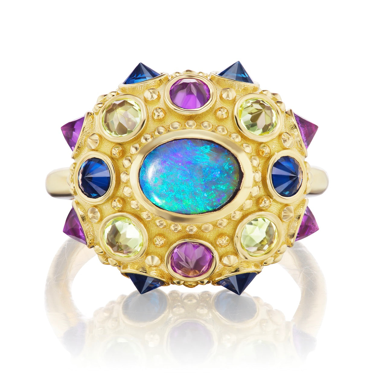 A top-down view of AnaKatarina's statement piece: the Blue Valentine Ring. Crafted from 18k yellow gold and adorned with a Lighting Ridge black opal and vibrant peridots, amethysts, and blue sapphires. With spiritual properties and an engraved 'LOVE', thi
