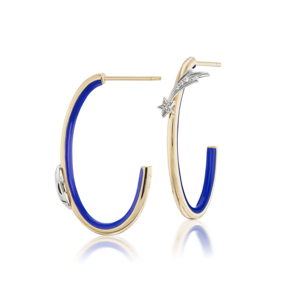 Side view of Ana-Katarina's 4 Elements Air Hoops: 18k gold, diamond, and blue enamel earrings with a star and moon, symbolizing the element of air and the cosmos. One hoop has a quarter moon & star, while the other has a shooting star design with a small diamond.