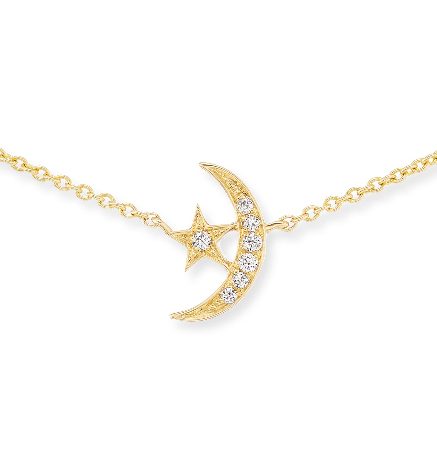 A closeup view of AK's 4 Elements Star and Moon Charm Necklace in 18 karat yellow gold with .03ct diamonds on a 16" gold adjustable chain.