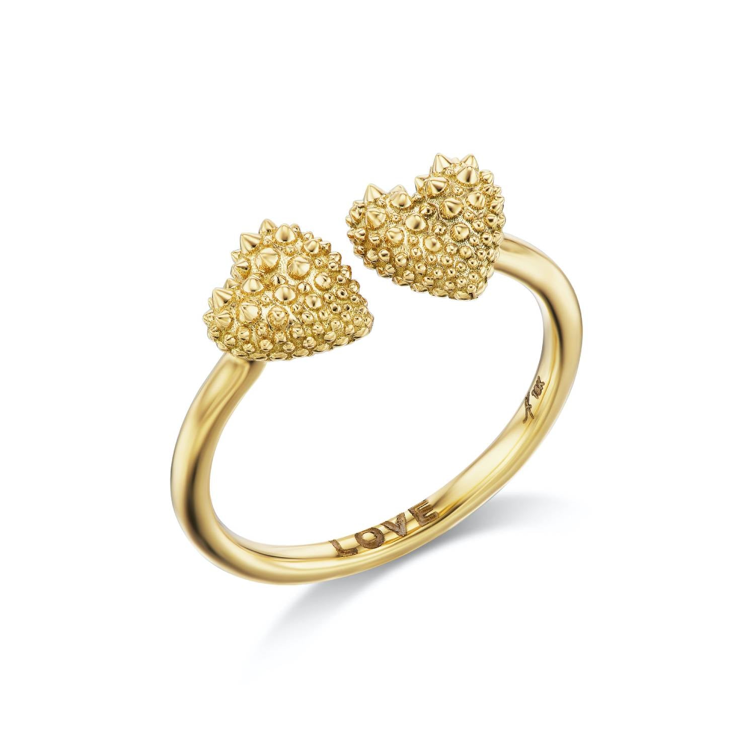 An 18k yellow gold ring with two spiked hearts side by side for a new spin on the classic 'moi et toi' design. The word 'love' is shown engraved inside the band of the ring designed by Ana-Katarina fine jewelry.