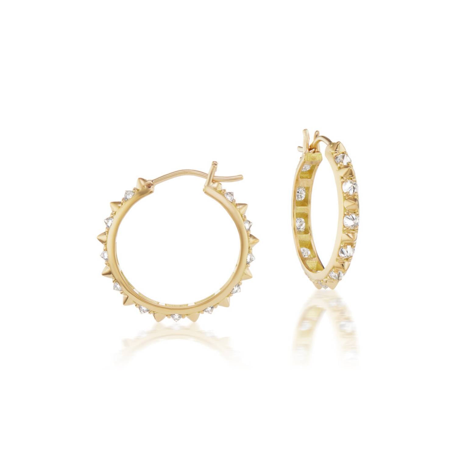 A side view of the opulent Large Valerie Diamond Hoops in white and yellow, crafted with 18k yellow gold and adorned with inverted diamonds and gold spikes, they're a reinvented classic gold hoop earring.