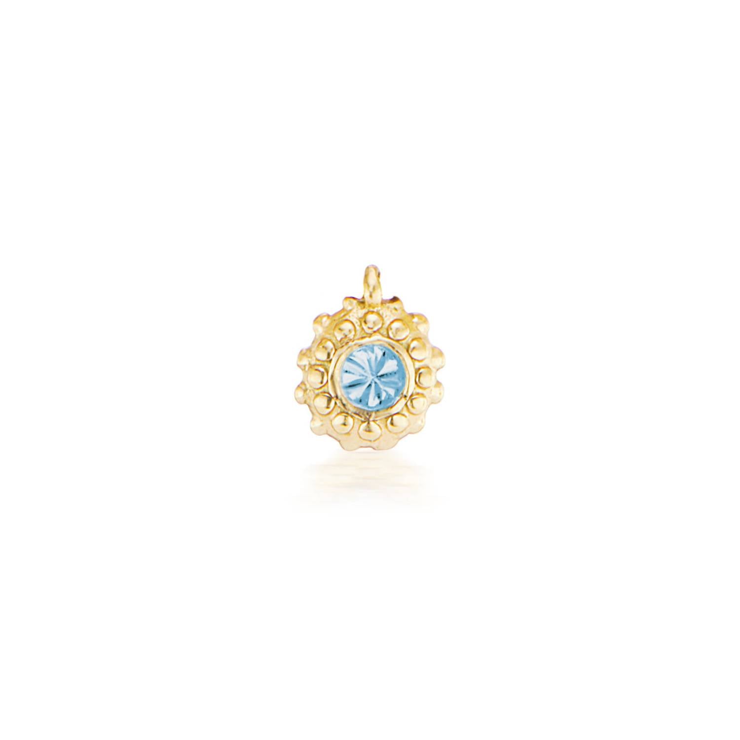 An 18k yellow gold circular charm with raised soft 'spikes' and an inverted aquamarine for the March / Pisces birthstone in the center.