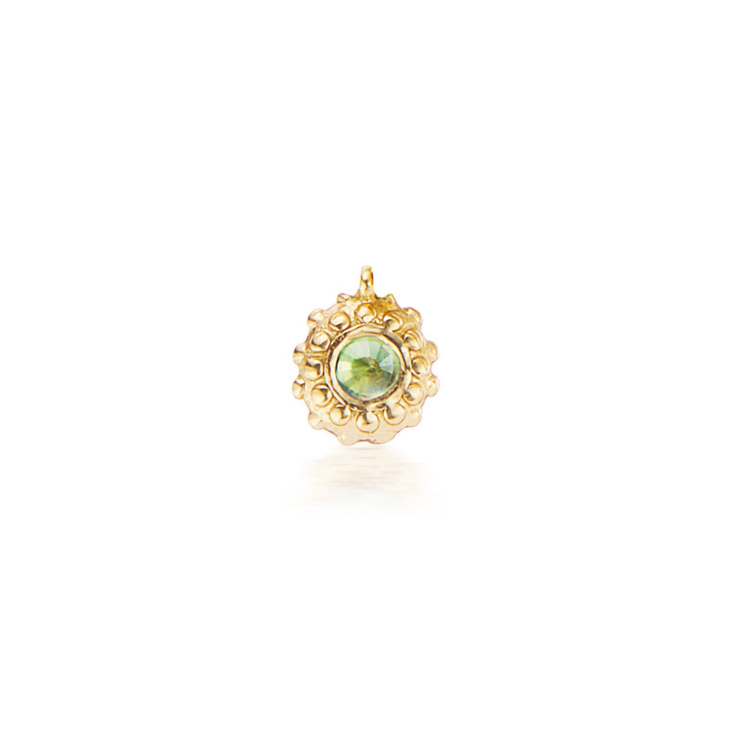 An 18k yellow gold circular charm with raised soft 'spikes' and an inverted peridot for the August / Leo birthstone in the center.