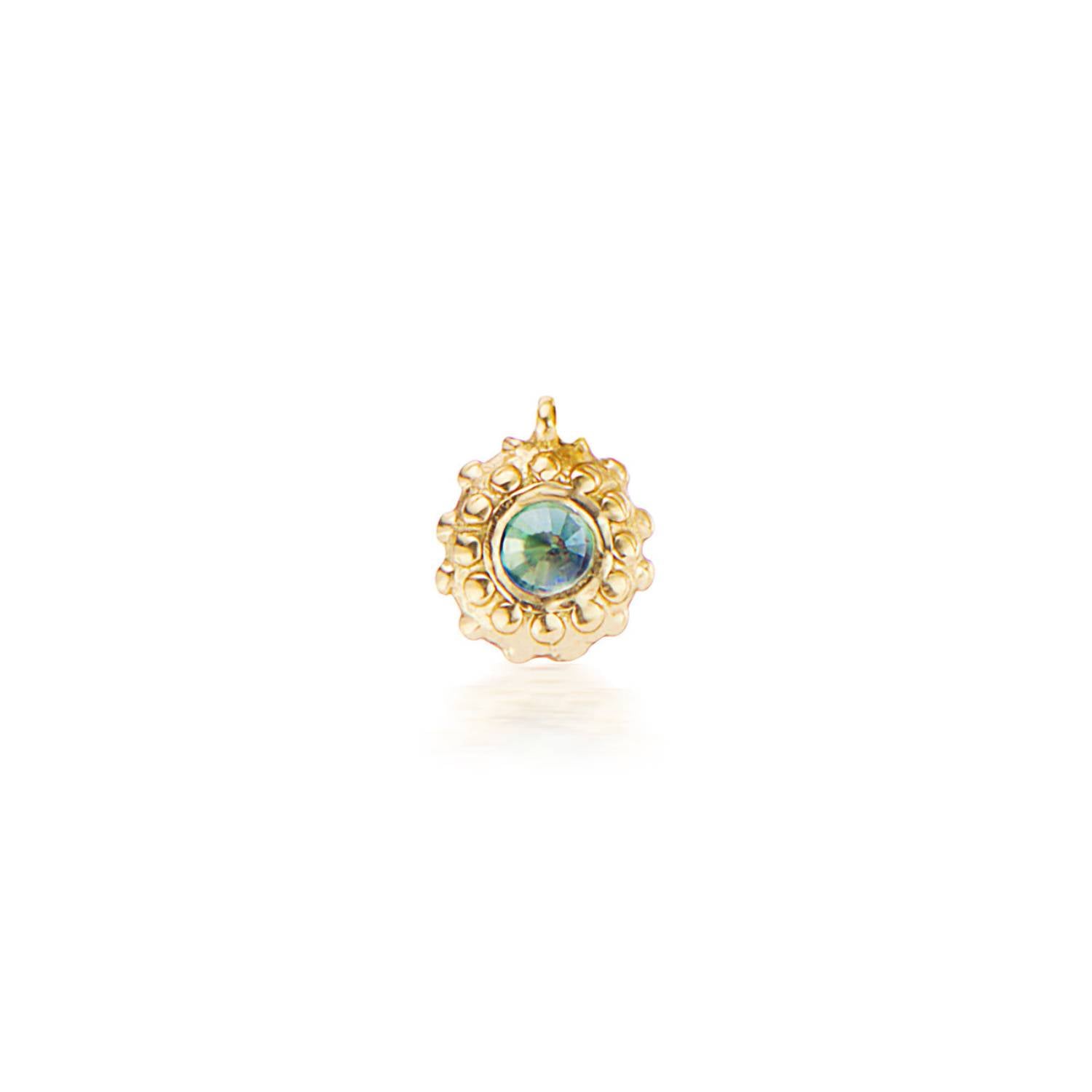 An 18k yellow gold circular charm with raised soft 'spikes' and an inverted alexandrite for the June / Gemini birthstone in the center.
