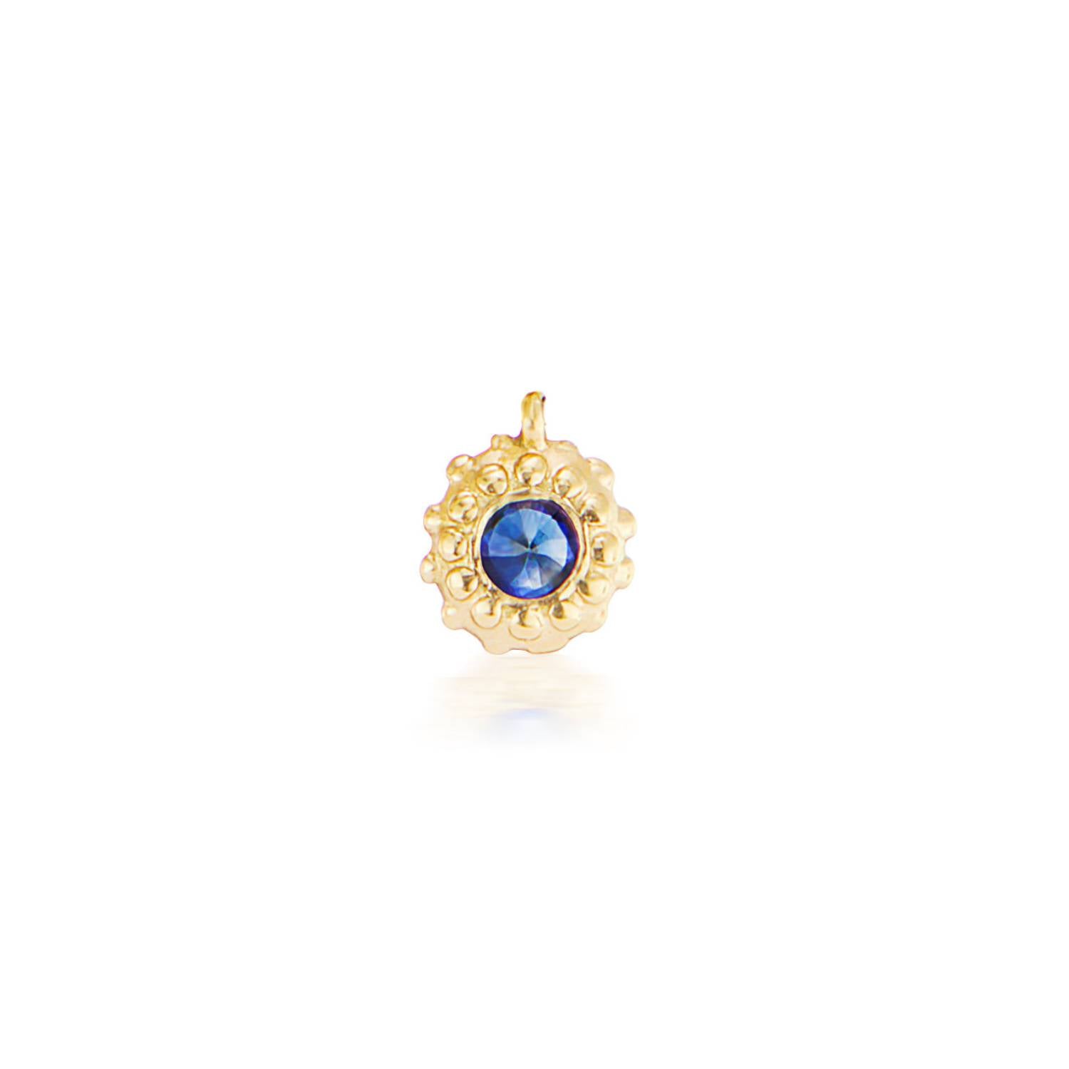 An 18k yellow gold circular charm with raised soft 'spikes' and an inverted blue sapphire for the September / Virgo birthstone in the center.