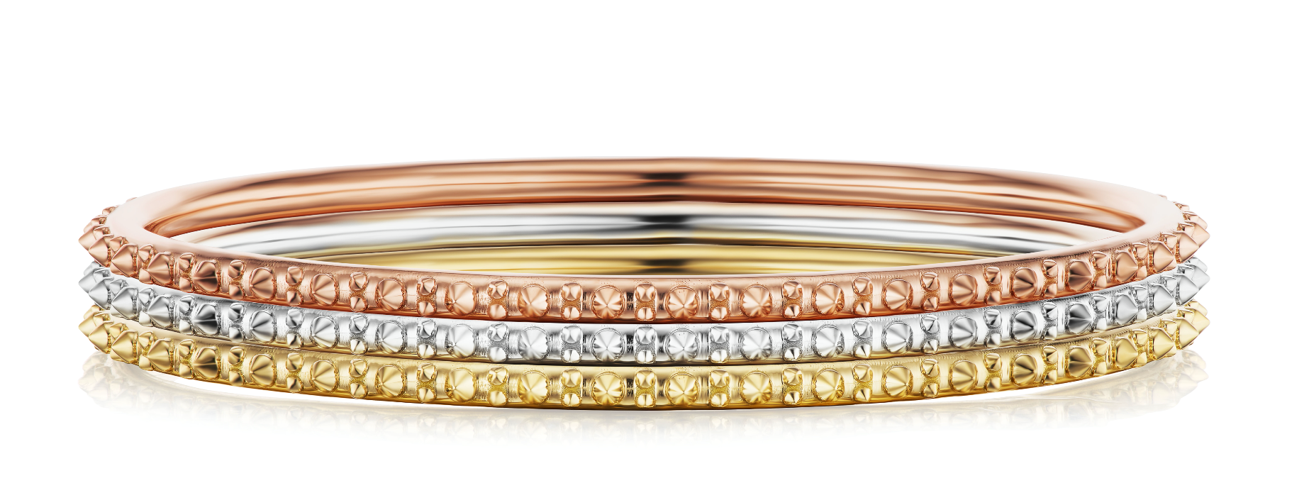 Three colors of AnaKatarina's Attitude Gold 'Adrina Loves a Bangle' are an 18-karat stack of rose, white, and yellow gold bangles. In her reinvention of the classic bangle, AK combines traditional form with a fusion of spikes for a little edge.