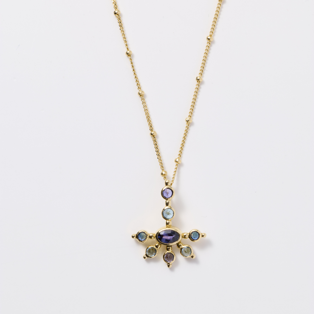 AnaKatarina Purple Haze Mini Funny Valentine pendant with purple and blue sapphires and aquamarines in yellow gold on an AK Saturn chain.