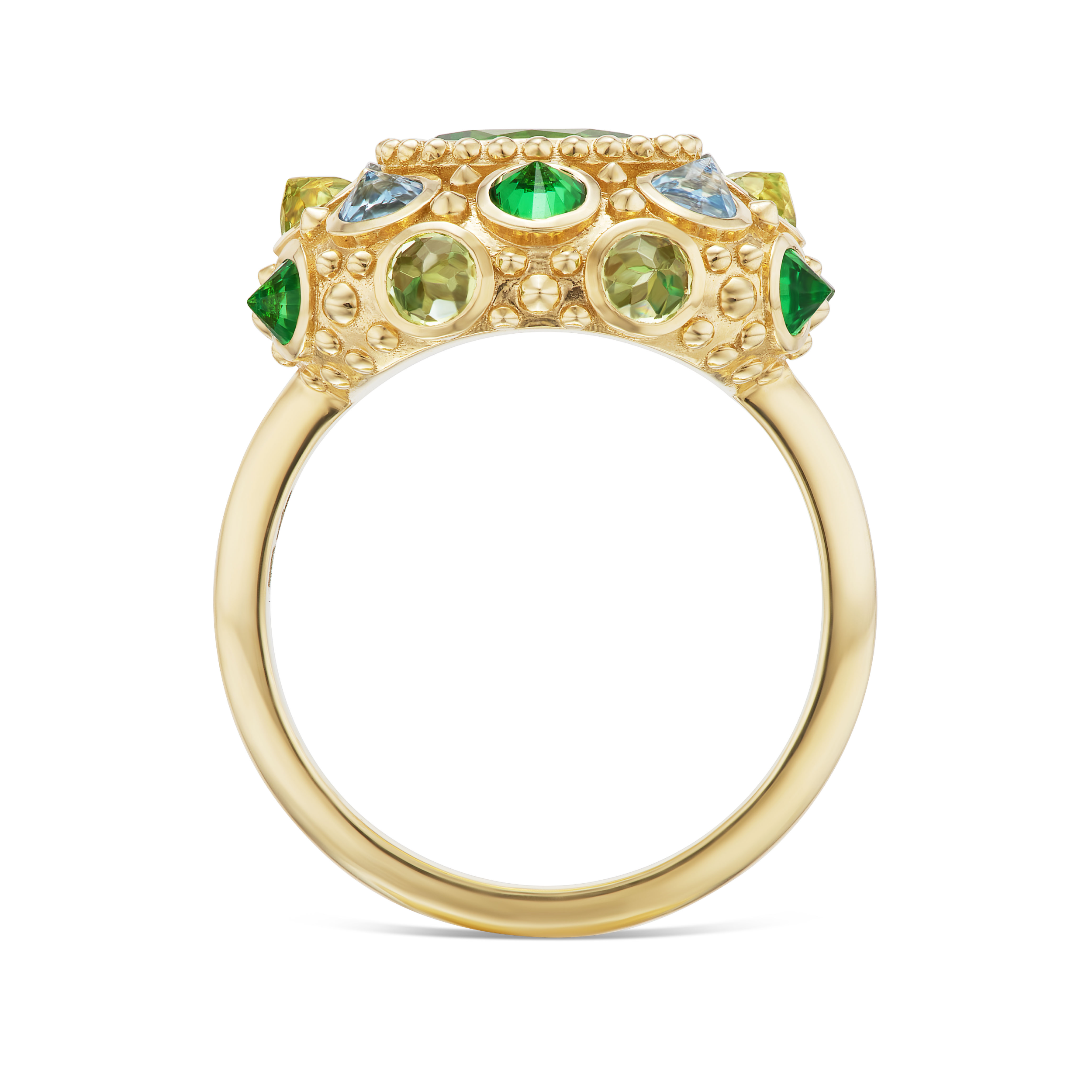 A side view of an 18K Yellow Gold ring designed by AnaKatarina featuring a vibrant arrangement of Tsavorite Garnets, Aquamarines & Peridot in the colors of blue & green creating a captivating & colorful display.