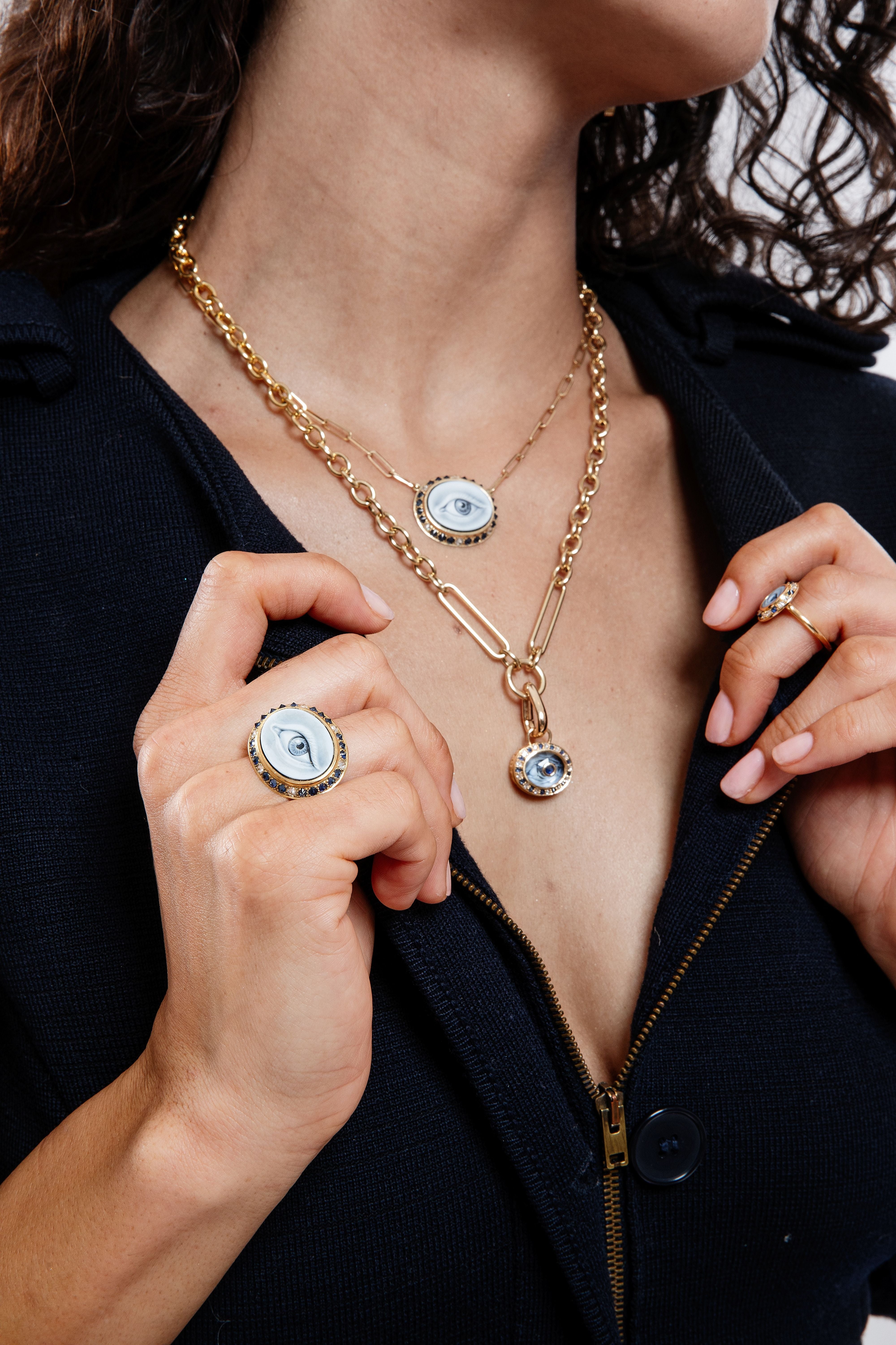 A model wearing black to highlight the 18k gold ‘Eye Lovey’ pendant styled on the 18” ‘Olivia’ yellow gold chain with other jewelry from Ana-Katarina’s ‘Eye Love’ Collection.