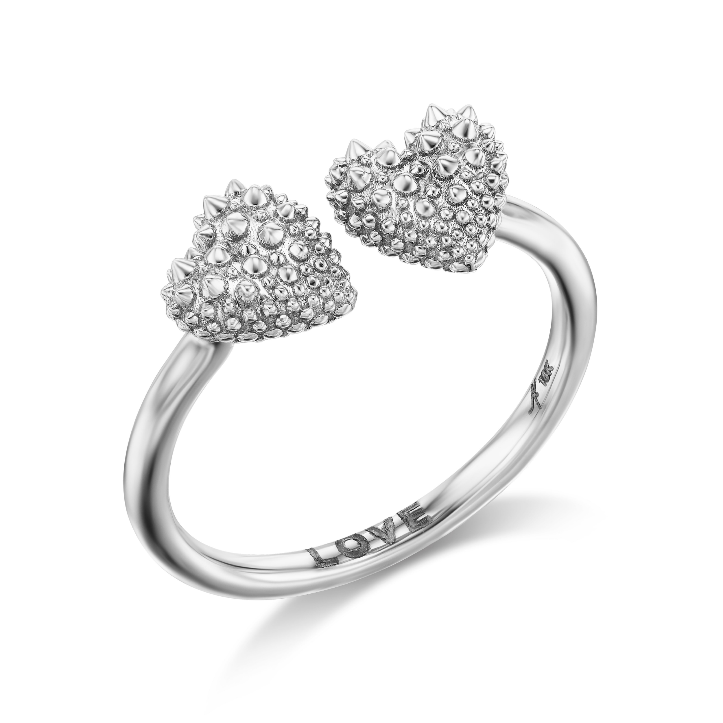 An 18k white gold ring with two spiked hearts side by side for a new spin on the classic 'moi et toi' design. The word 'love' is shown engraved inside the band of the ring designed by Ana-Katarina fine jewelry.
