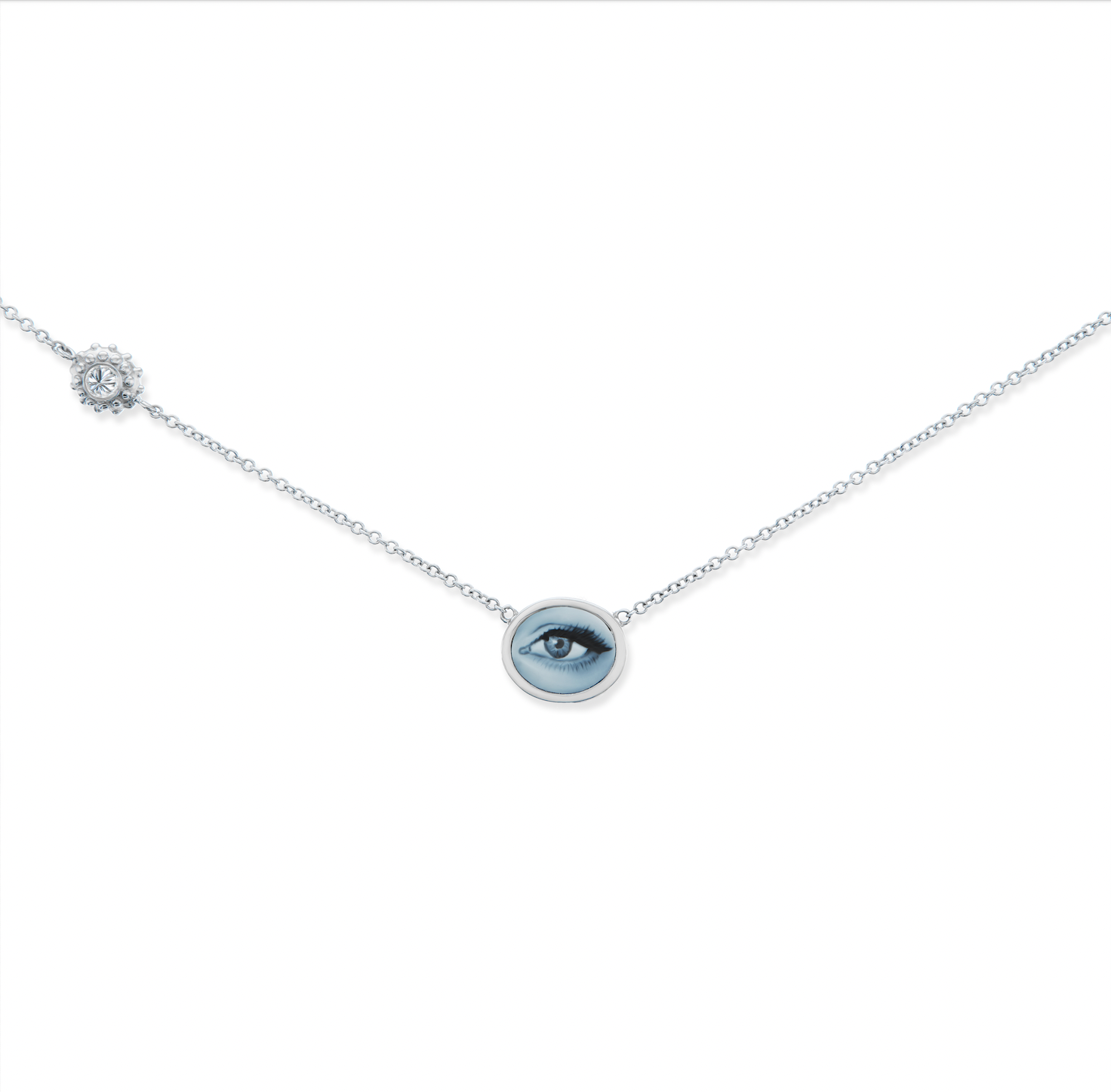 An 18k white gold & diamond necklace with a blue agate ‘Eye Love’ Cameo of a human eye set on a white gold chain with an inverted diamond charm. Designed & hand-crafted by Ana-Katarina Fine Jewelry.