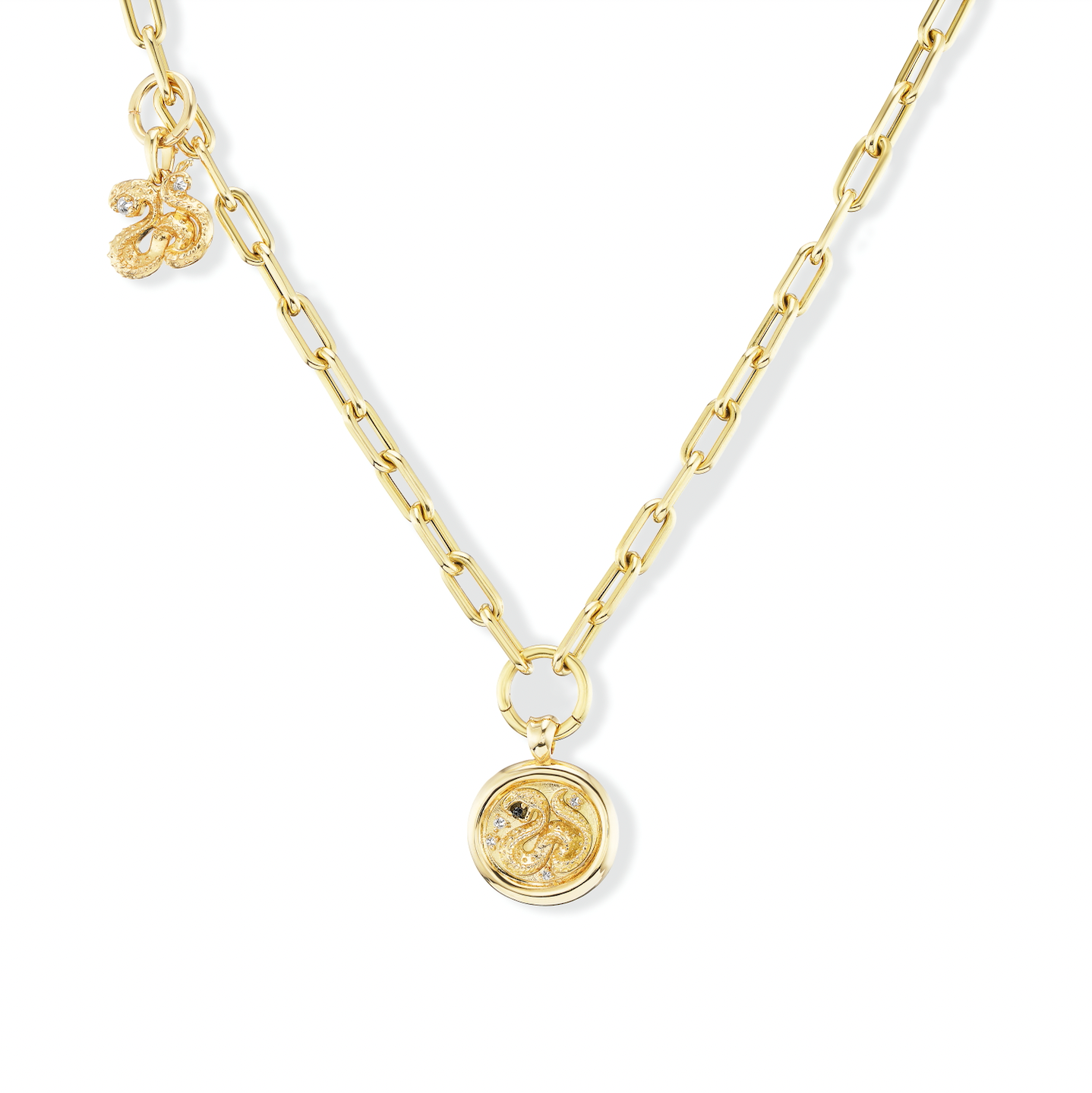 A gold chain with interchangeable pendants and charms added using ‘Charm-ing’ Link-style charm holders designed by Ana-Katarina Fine Jewelry. Gold serpent pendants with inverted diamonds and blue sapphires hang from the gold chain - all gold chains, gold pendants, and gold charms designed by Ana-Katarina. 