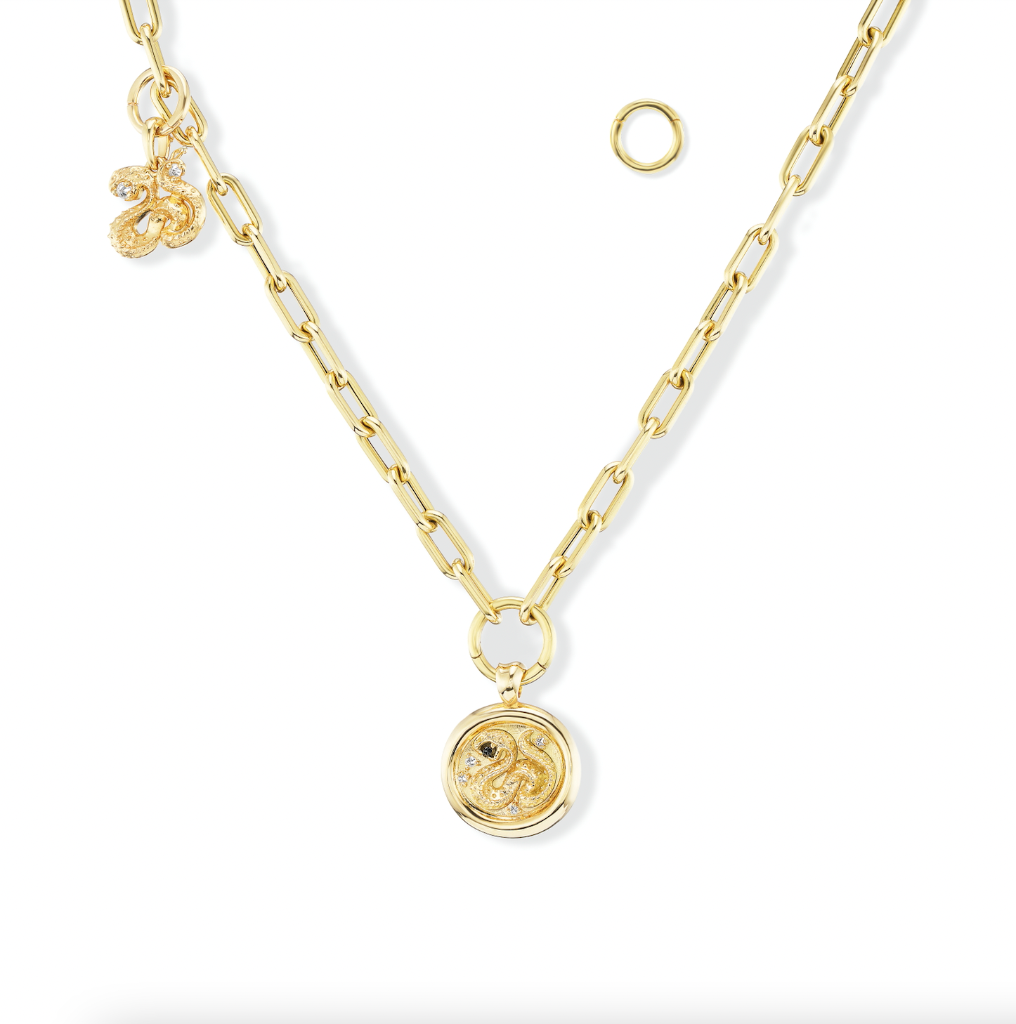 A gold chain with interchangeable pendants and charms added using ‘Charm-ing’ Link-style charm holders designed by Ana-Katarina Fine Jewelry. Gold serpent pendants with inverted diamonds and blue sapphires hang from the gold chain - all designed by Ana-Katarina. 