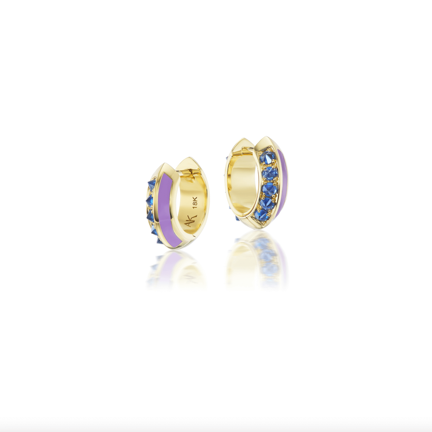 A frontal view of the 'Sweet, Happy Life' Blue Sapphire Drop Huggie earrings in 18k yellow gold, embellished with alluring .62tw Blue Sapphires and Lavender Enamel designed by Ana-Katarina Fine Jewelry. 