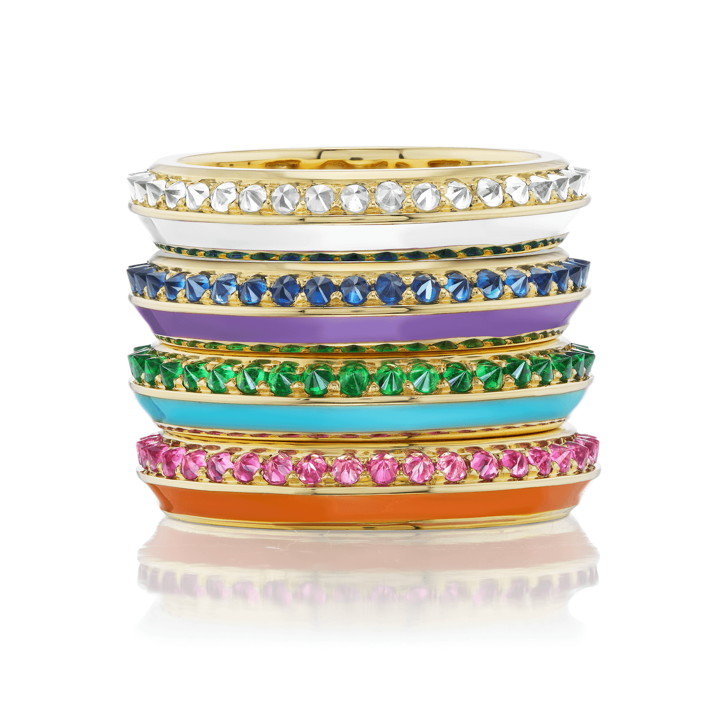 Four stacking rings from AnaKatarina's 'Sweet, Happy Life' collection. From top to bottom are: the 'Sweet, Happy Life' Stacking Diamond Ring in 18k yellow gold, embellished with mesmerizing .60ct diamonds and in pristine white enamel, the 'Sweet, Happy Li