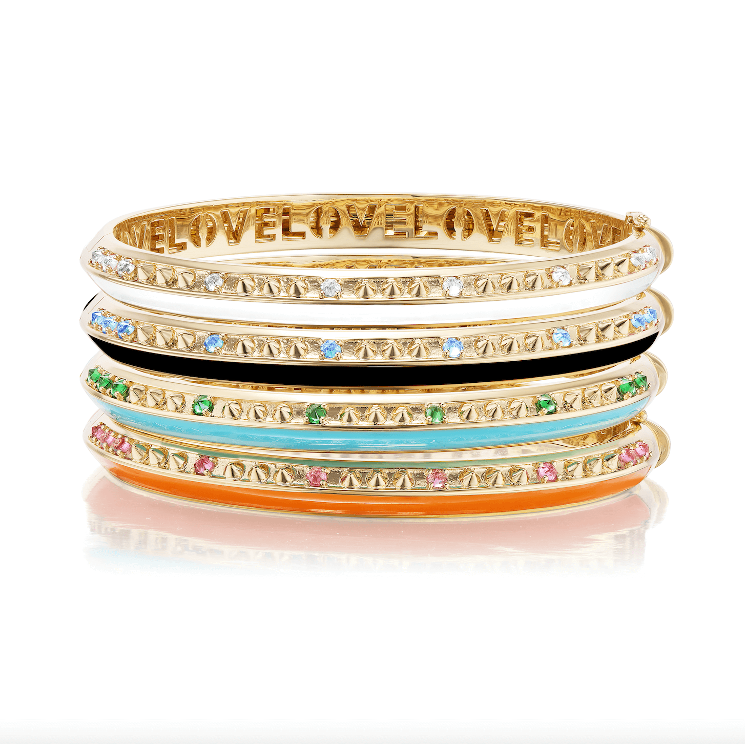 A side view of all four "Sweet, Happy Life' bangles designed by AnaKatarina stacked together, featuring the word ‘love’ inset inside the bracelet. The ‘Sweet, Happy Life’ collection includes blue topaz, tsavorite garnet, pink tourmaline, and diamond bangles in 18k yellow gold. Designed by Ana-Katarina Fine Jewelry.