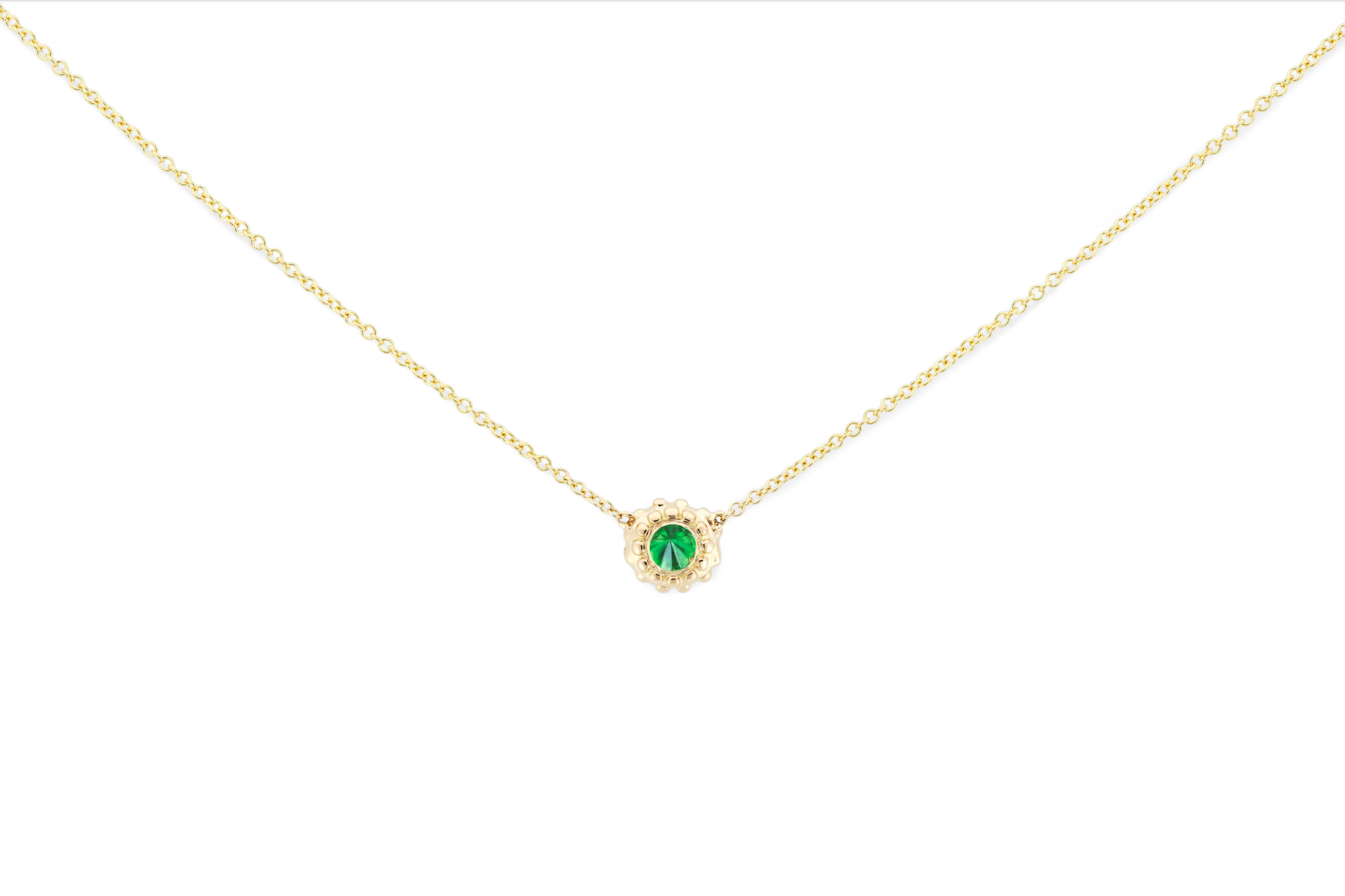 A delicate 18k yellow gold and inverted green Tsavorite Garnet necklace with an adjustable 18" cable chain inspired by the totemic symbolism of the sea urchins along the California coast and designed by Ana-Katarina Fine Jewelry. 