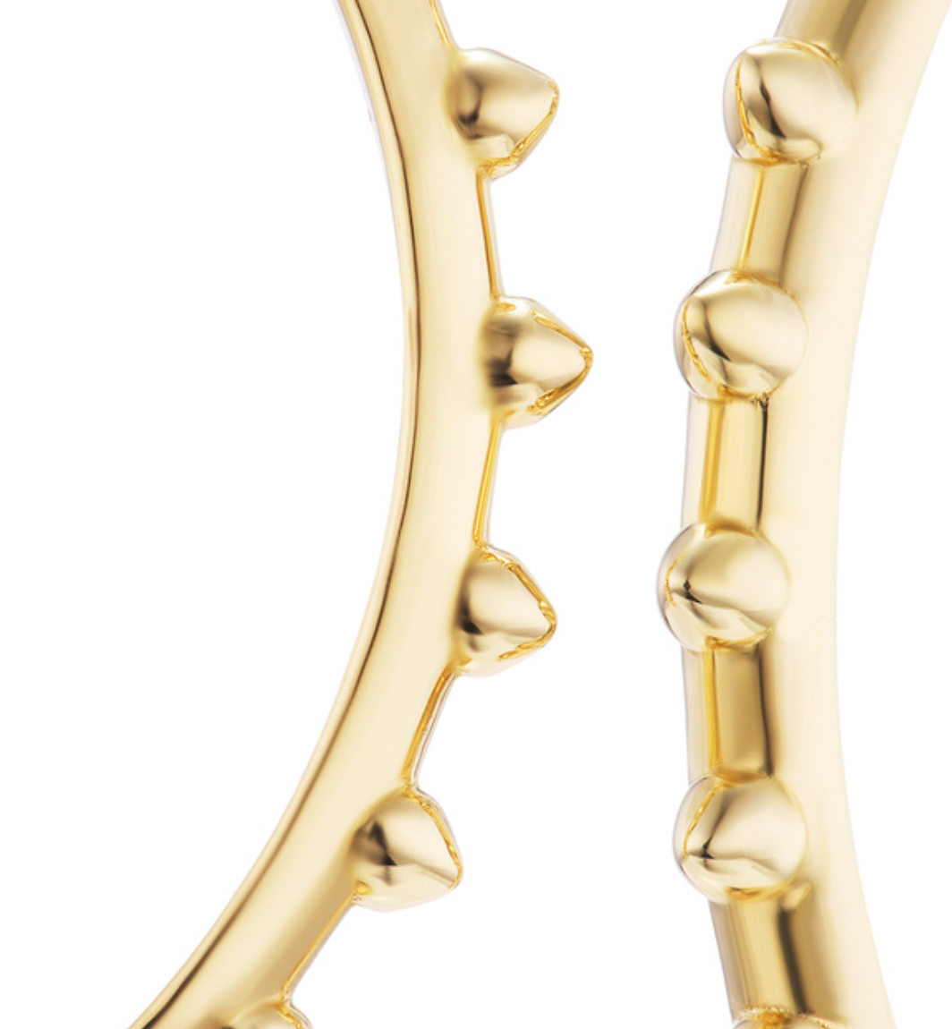 A closeup view of Ana-Katarina's 'Adrina Loves a Hoop' 18k gold hoop earrings to reveal the smoothed spikes & rounded design of the hoops. Designed by Ana-Katarina Fine Jewelry. 