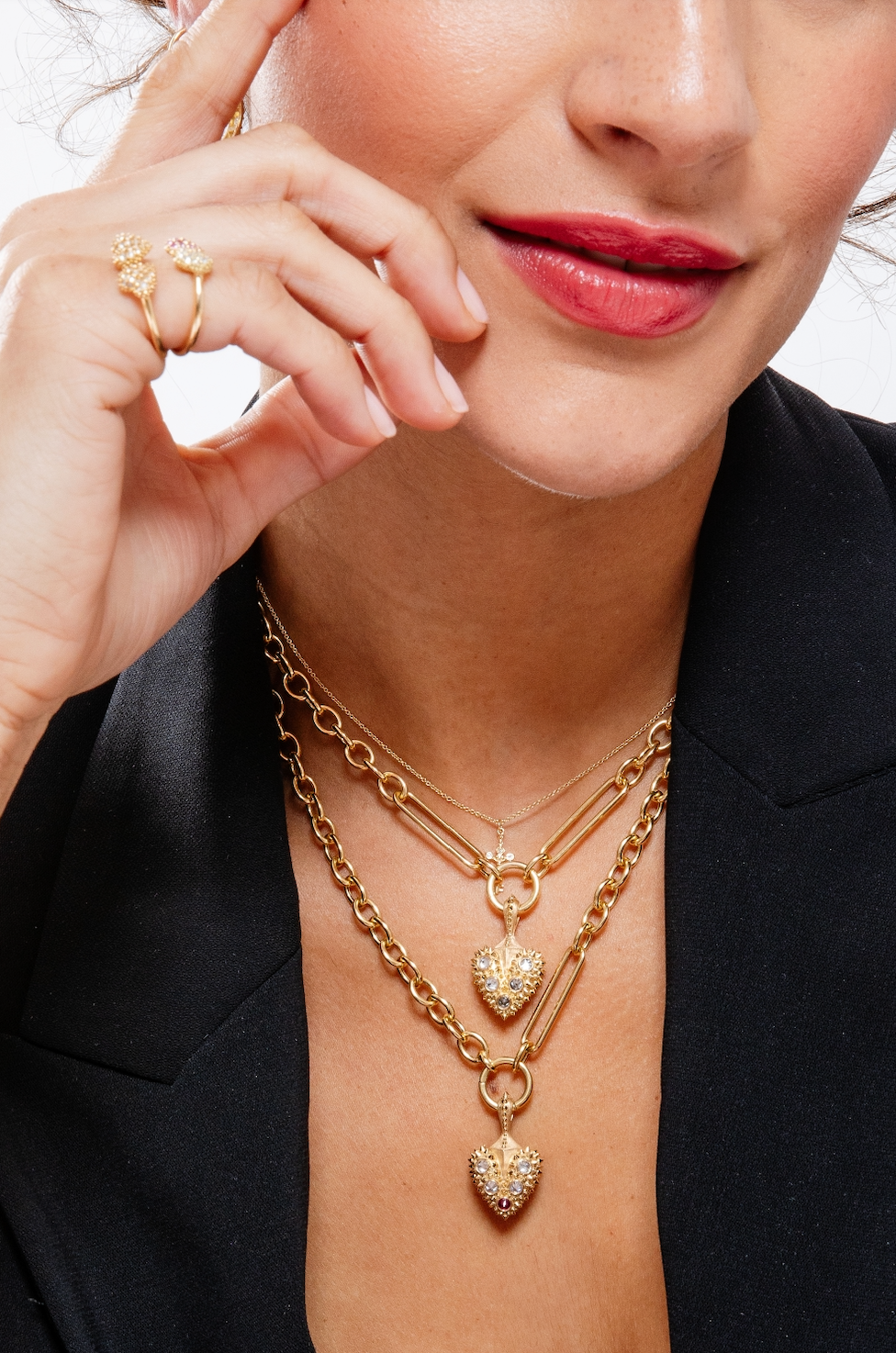 A model wearing two of Ana-Katarina’s bleeding heart pendants on large 18k yellow gold chains as well as other spiked heart rings and earrings from the ‘Pierce Your Heart’ collection. 