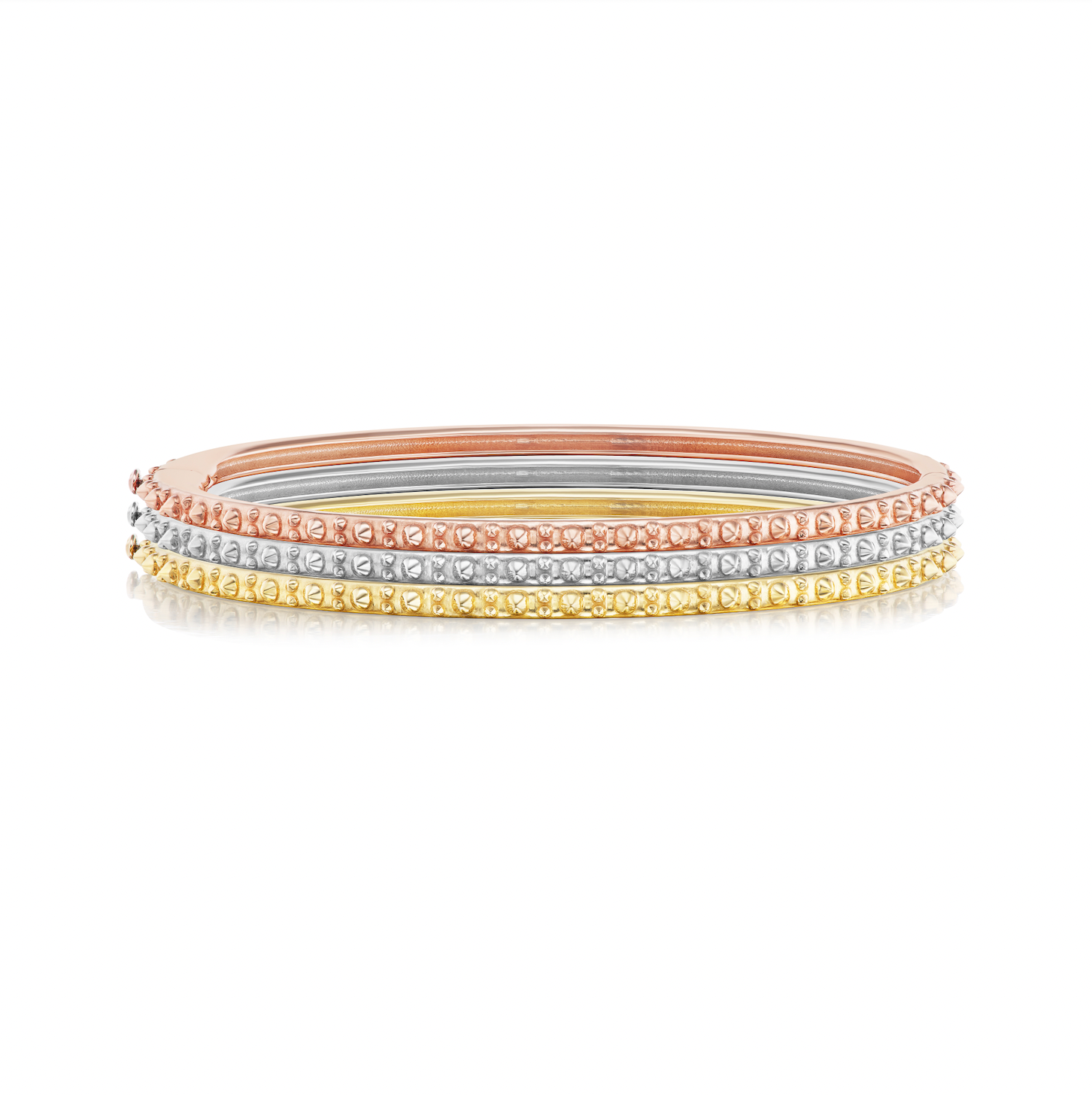 Three colors of AnaKatarina's Attitude Gold 'Adrina Loves a Bangle' are an 18-karat stack of rose, white, and yellow gold bangles. In her reinvention of the classic bangle, AK combines traditional form with a fusion of spikes for a little edge.