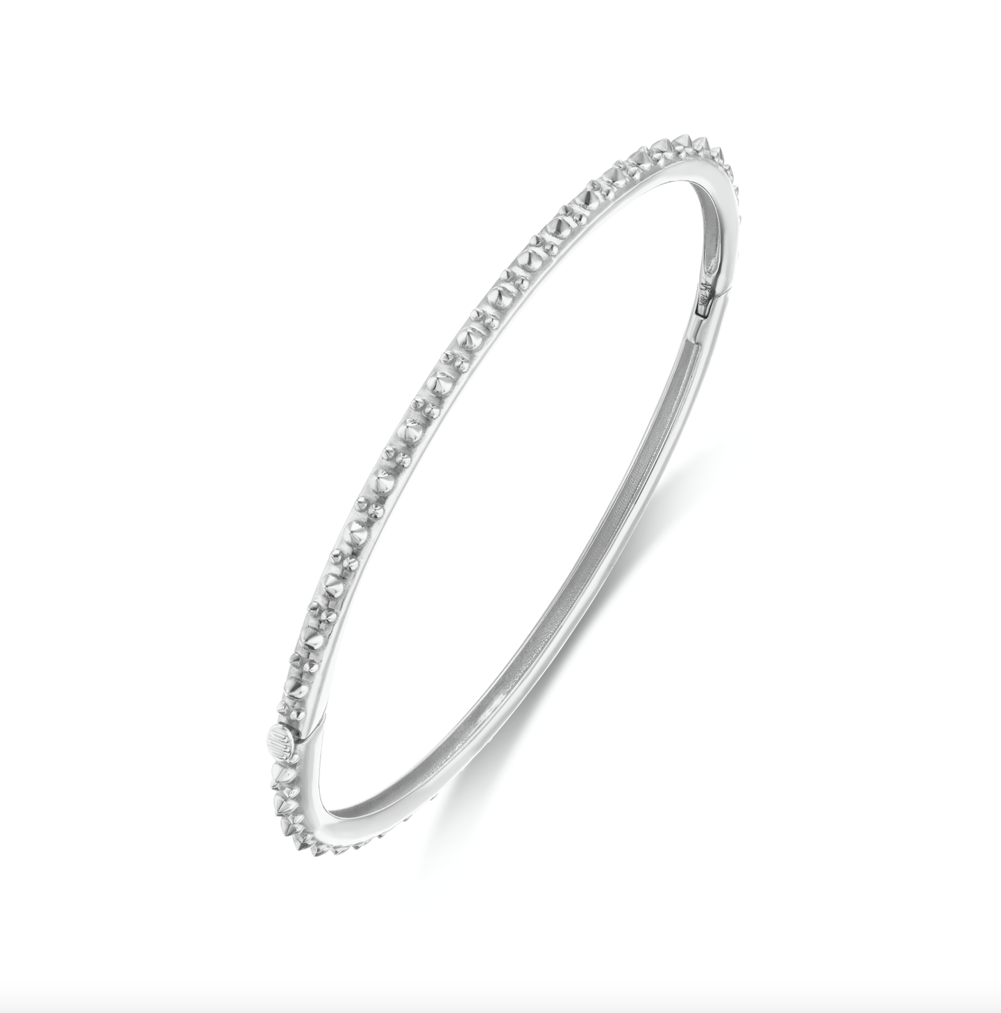 A perpendicular view of AnaKatarina's Attitude White Gold 'Adrina Loves a Bangle' 18 karat white gold bangle. In her reinvention of the classic bangle, AK combines traditional form with a fusion of confidence and femininity, showcasing 18k gold spikes. 