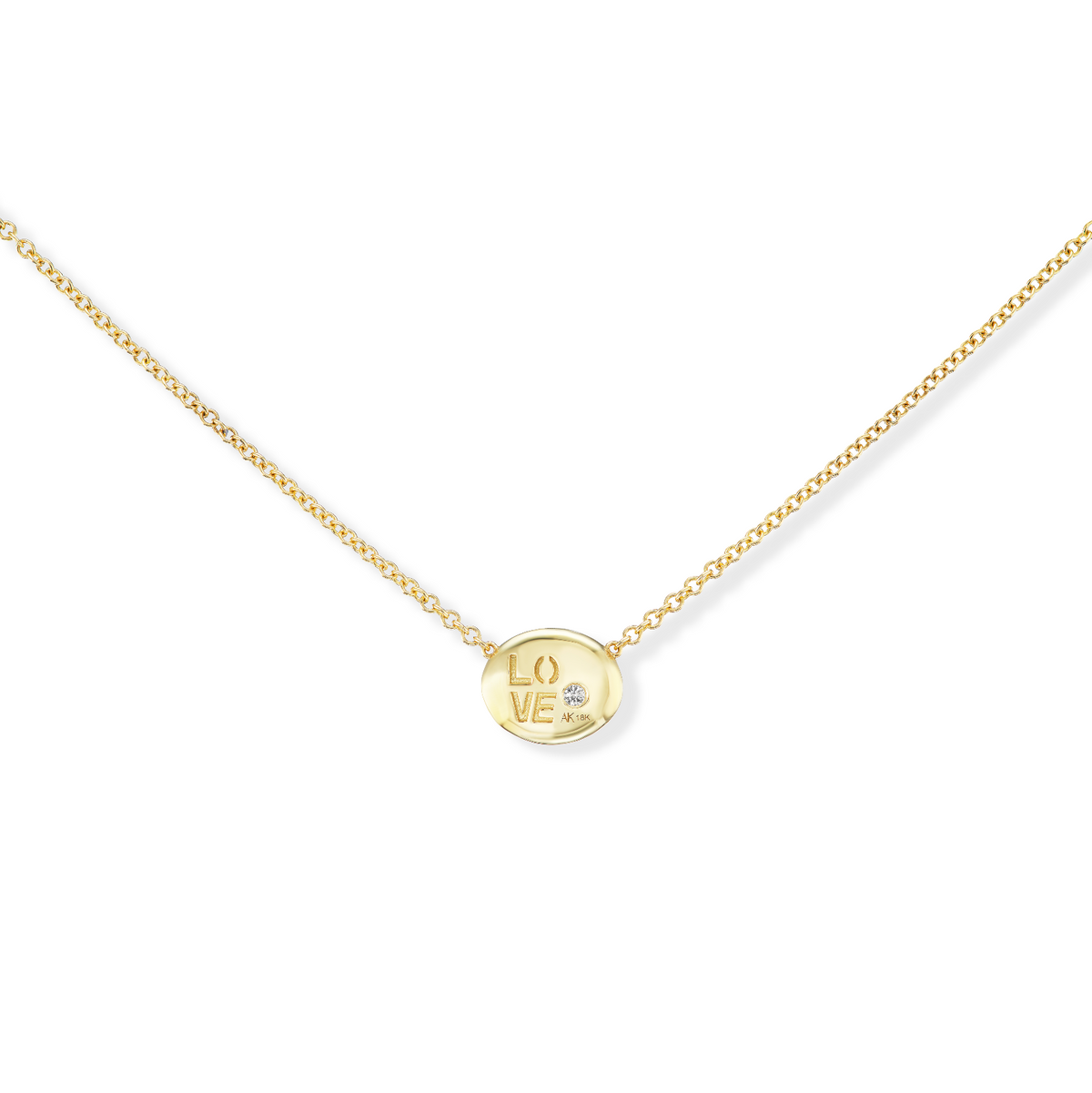 Back of AnaKatarina’s 18k yellow gold Pebble pendant with “Love” engraved and the diamond visible through an opening.

