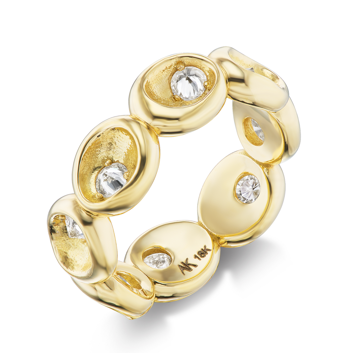 Three-quarter view of AnaKatarina’s Pebble eternity ring with rounded 18k gold pebble shapes and inverted-set diamonds.