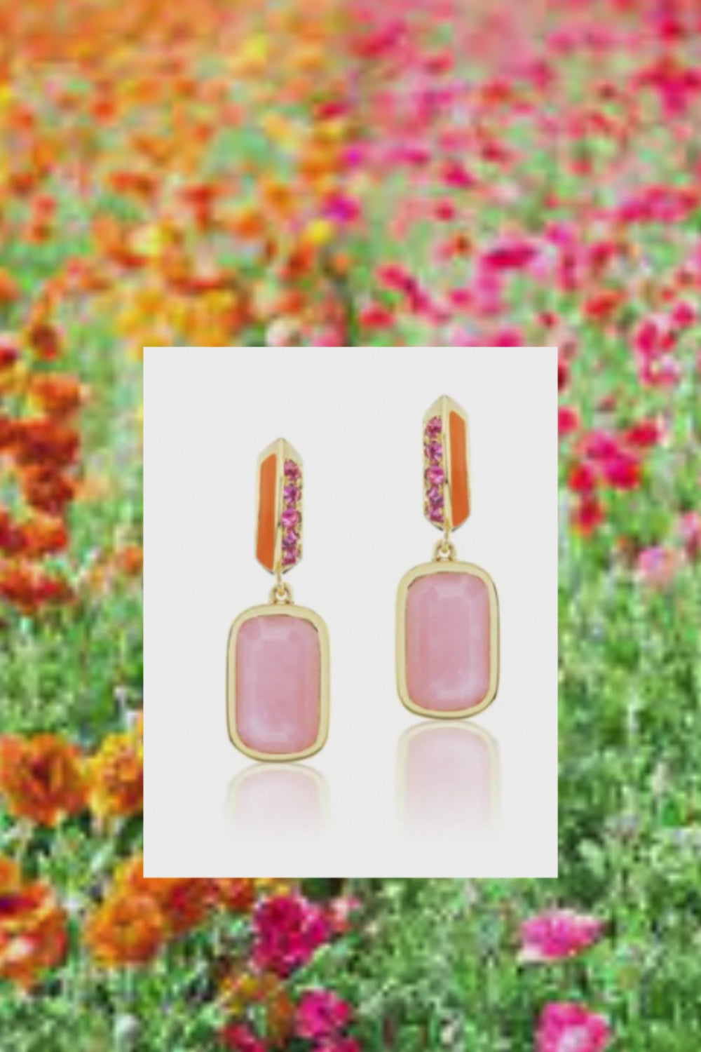 A video of the 'Sweet, Happy Life' Pink Tourmaline Drop Earrings designed by AnaKatarina. They are adorned with opulent 18K yellow gold accents and feature .48ct pink tourmaline, 5.3ct pink opal, and exquisite orange enamel against a background of pink and orange wildflowers. Designed by Ana-Katarina Fine Jewelry.