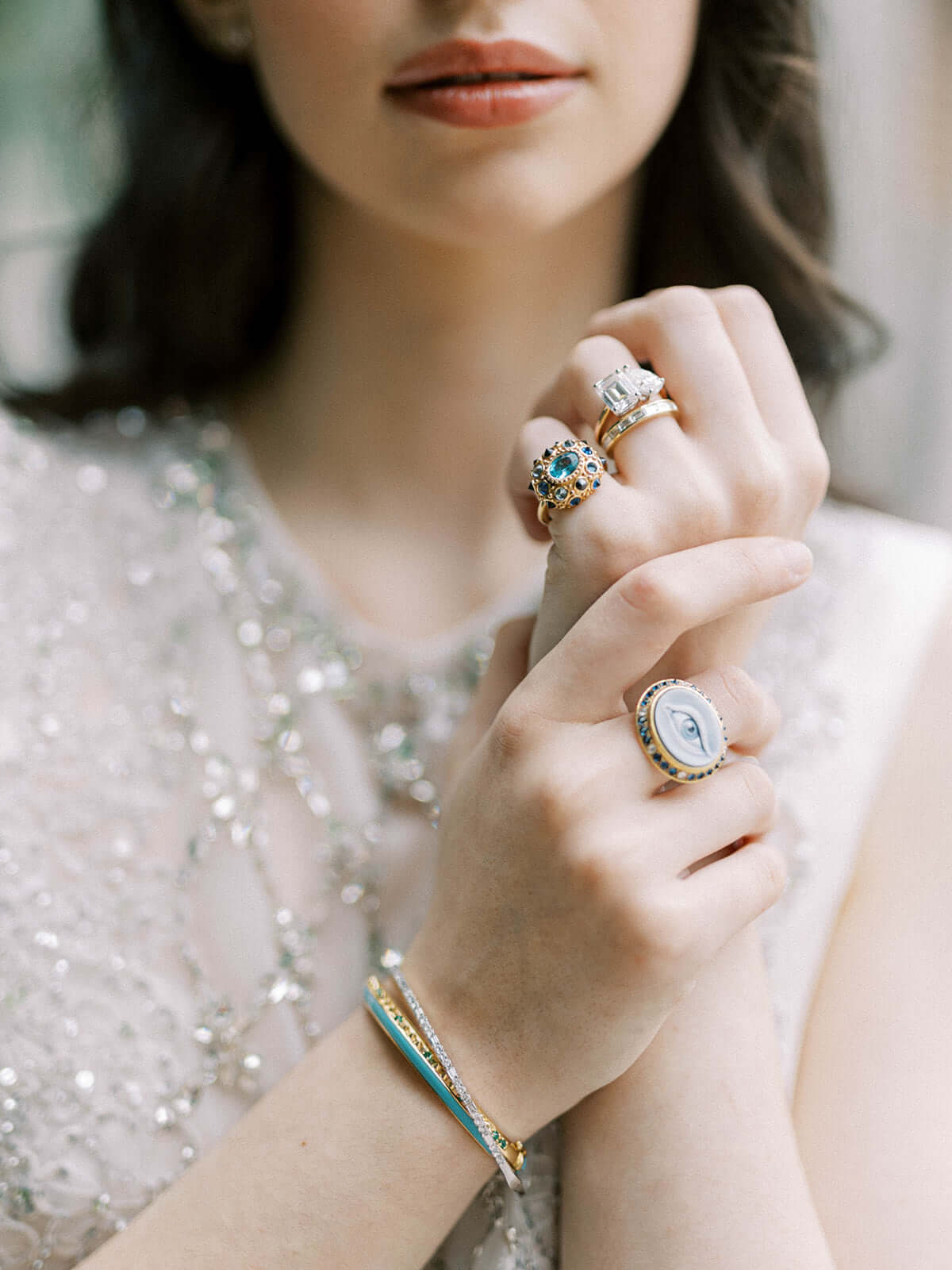 A person holding their wrist revealing a side view of the 'Sweet, Happy Life' Tsavorite Garnet stacking bangle designed by AnaKatarina Fine Jewelry - crafted from 18k Yellow Gold and embellished with .48tw Tsavorite Garnet.