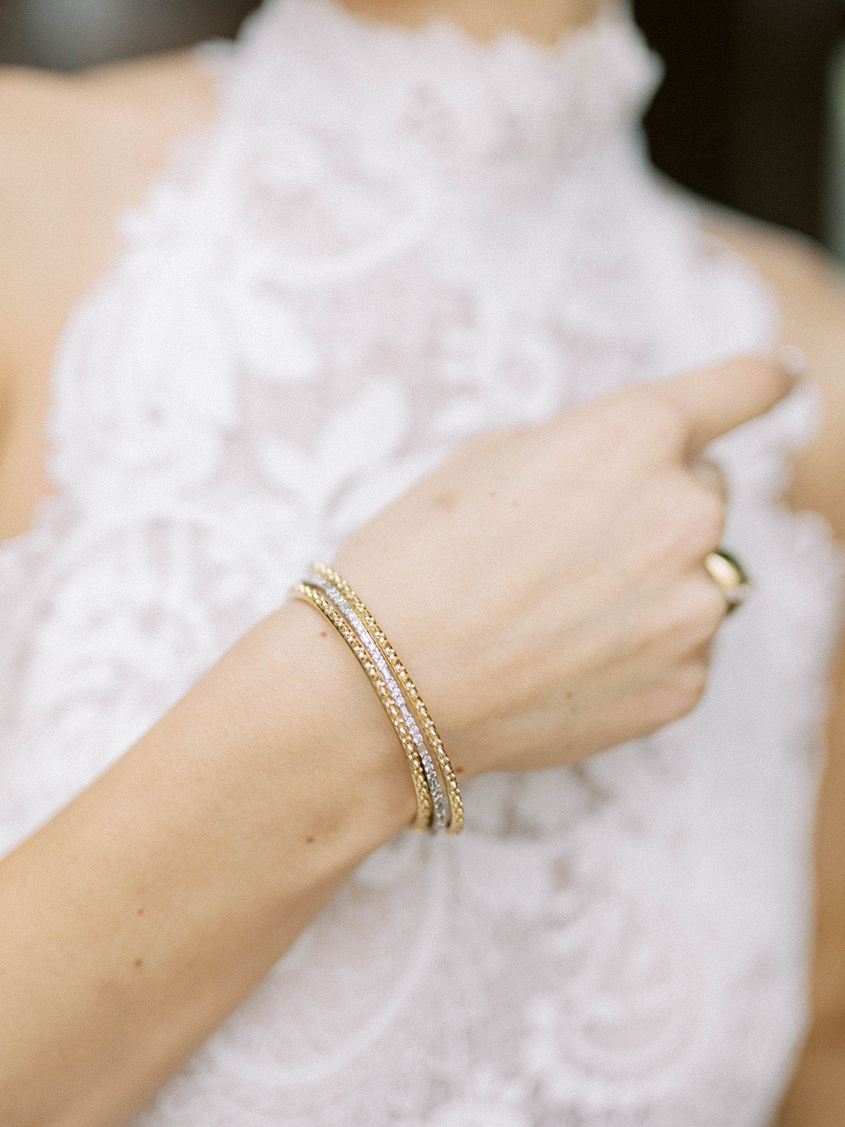 A model wearing AnaKatarina's Attitude Rose Gold 'Adrina Loves a Bangle' 18K rose gold bangle. In her reinvention of the classic bangle, AK combines traditional form with a fusion of confidence and femininity, showcasing luxurious 18k gold spikes.