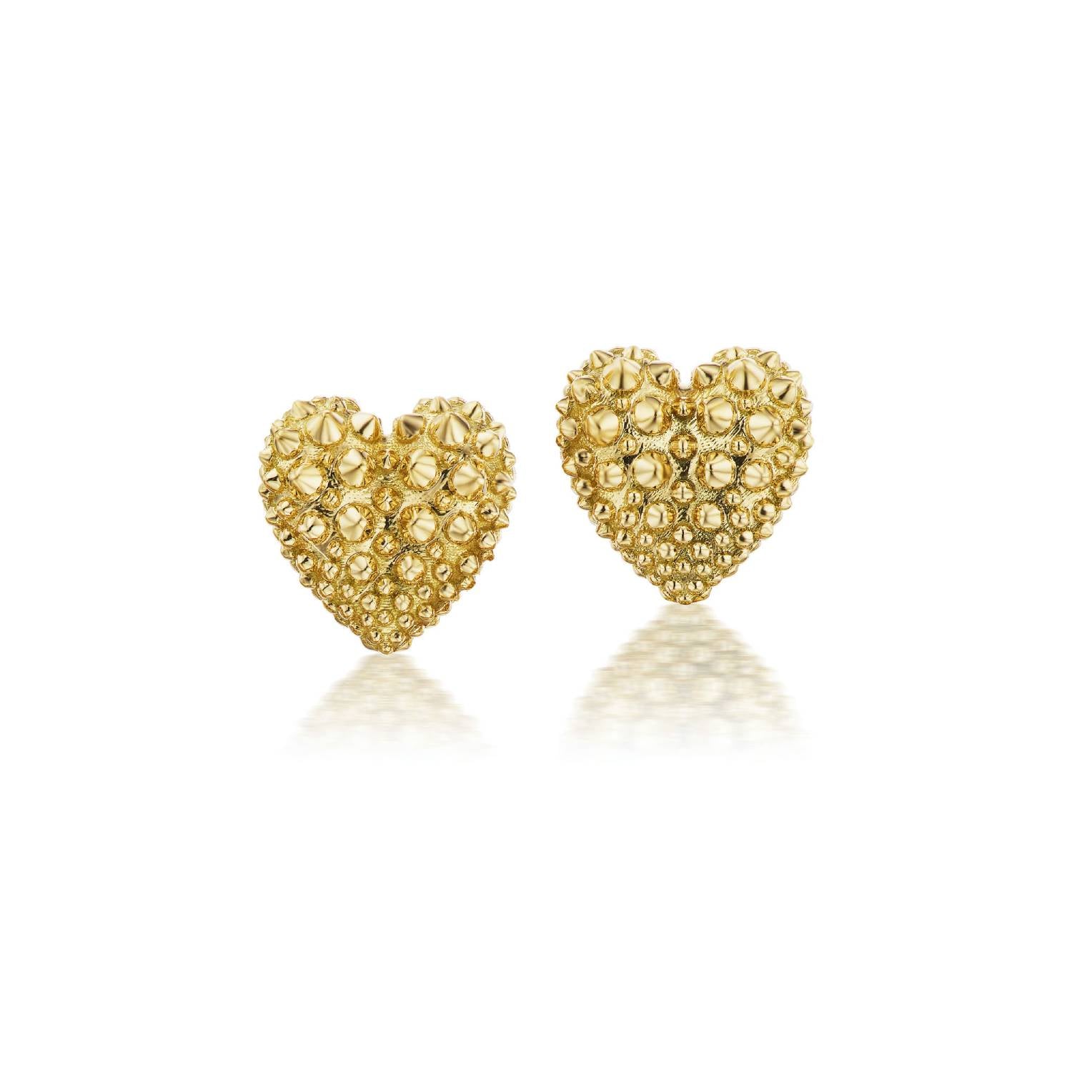 A front view of a pair of 18k yellow gold heart stud earrings with soft gold spikes from Ana-Katarina’s ‘Pierce Your Heart’ collection. 