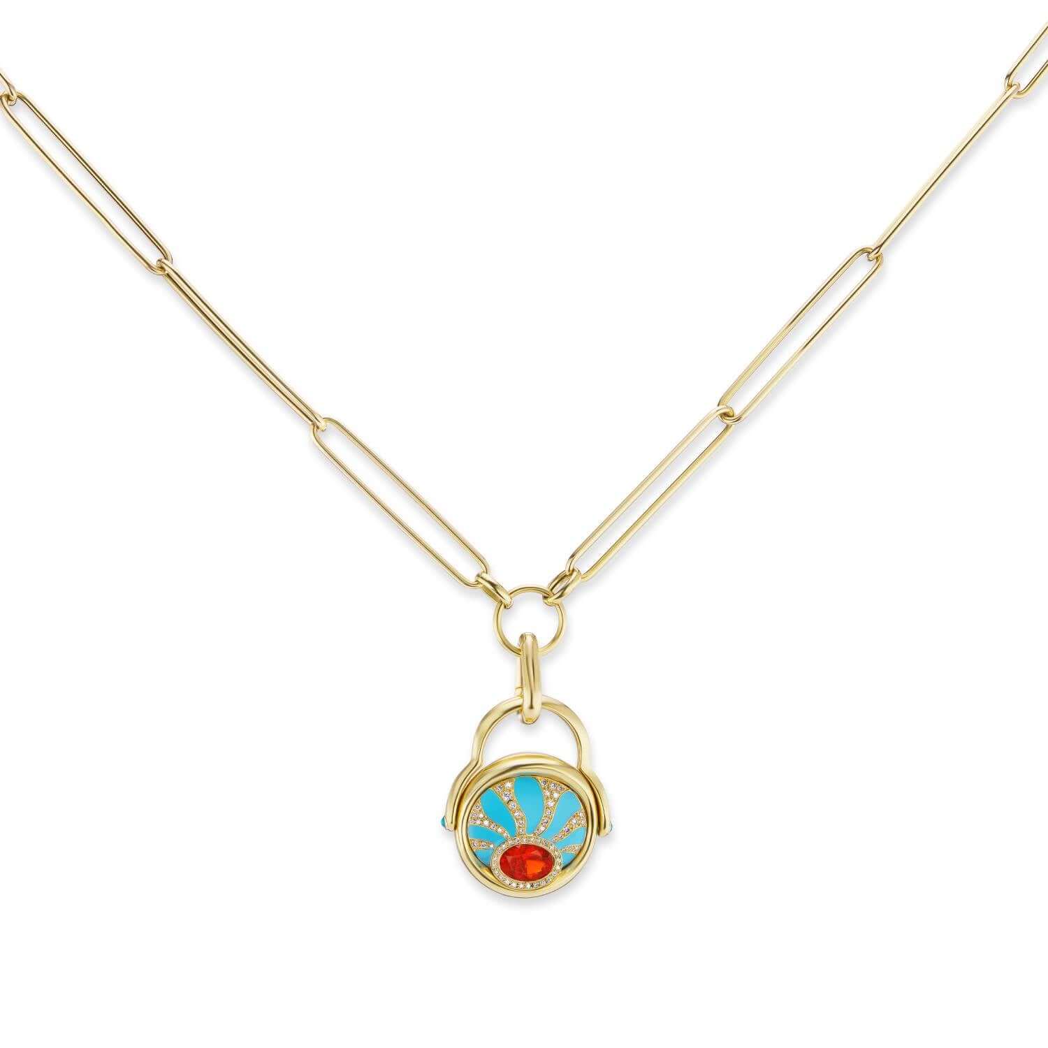 An 18k yellow gold paperclip chain with elongated links and a gold loop at the bottom to accommodate gold charms and gold pendants. Here, AK’s carabiner-style charm holder holds the ‘4 Elements: Fire’ gold flip ring to convert it to a necklace. Designed by Ana-Katarina Fine Jewelry. 