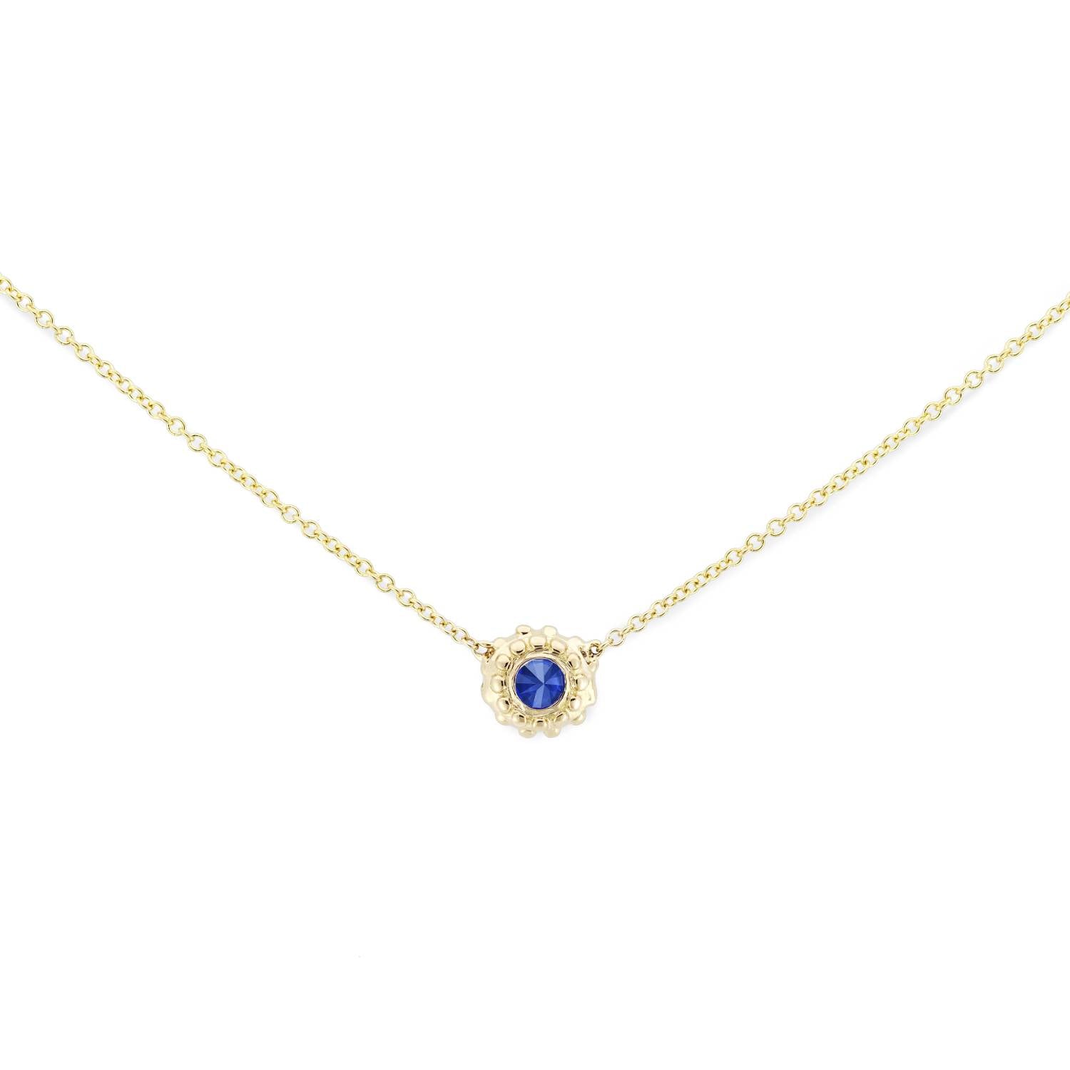 A delicate 18k yellow gold and inverted blue sapphire solitaire necklace with an adjustable 18" cable chain inspired by the totemic symbolism of the sea urchins along the California coast and designed by Ana-Katarina Fine Jewelry. 