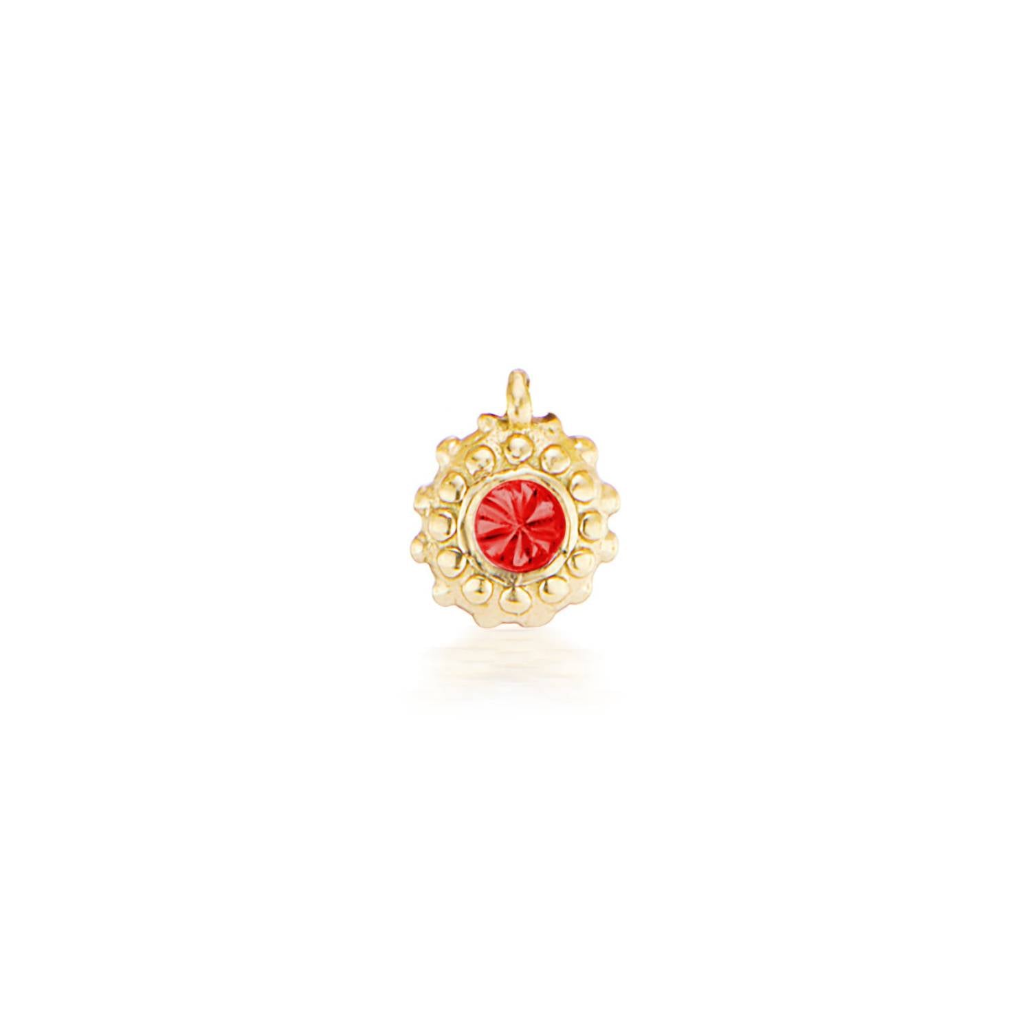 An 18k yellow gold circular charm with raised soft 'spikes' and an inverted ruby for the July / Cancer birthstone in the center. 
