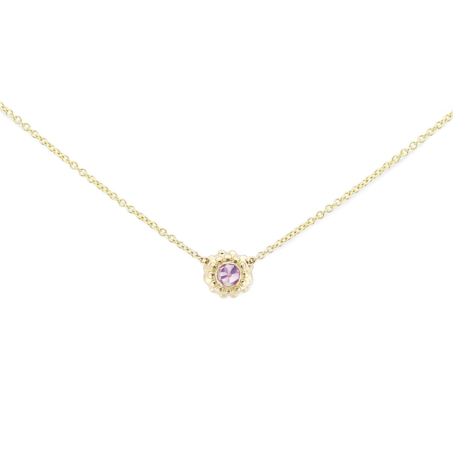A delicate 18k yellow gold and inverted pink sapphire solitaire necklace with an adjustable 18" cable chain inspired by the totemic symbolism of the sea urchins along the California coast and designed by Ana-Katarina Fine Jewelry. 