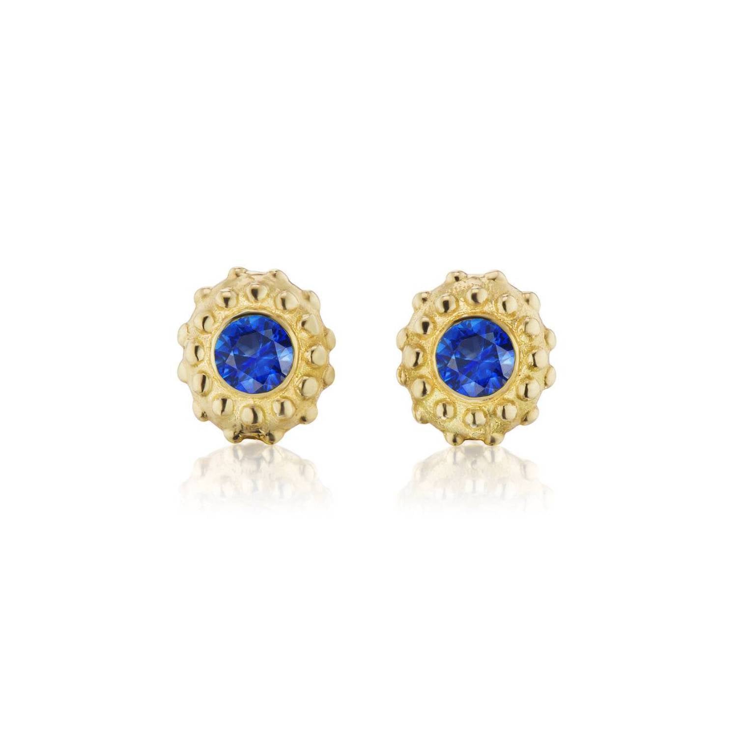 A set of 18k yellow gold and inverted blue sapphire stud earrings with soft gold beading in the setting designed after the delicate design of a sea urchin by Ana-Katarina Fine Jewelry. 