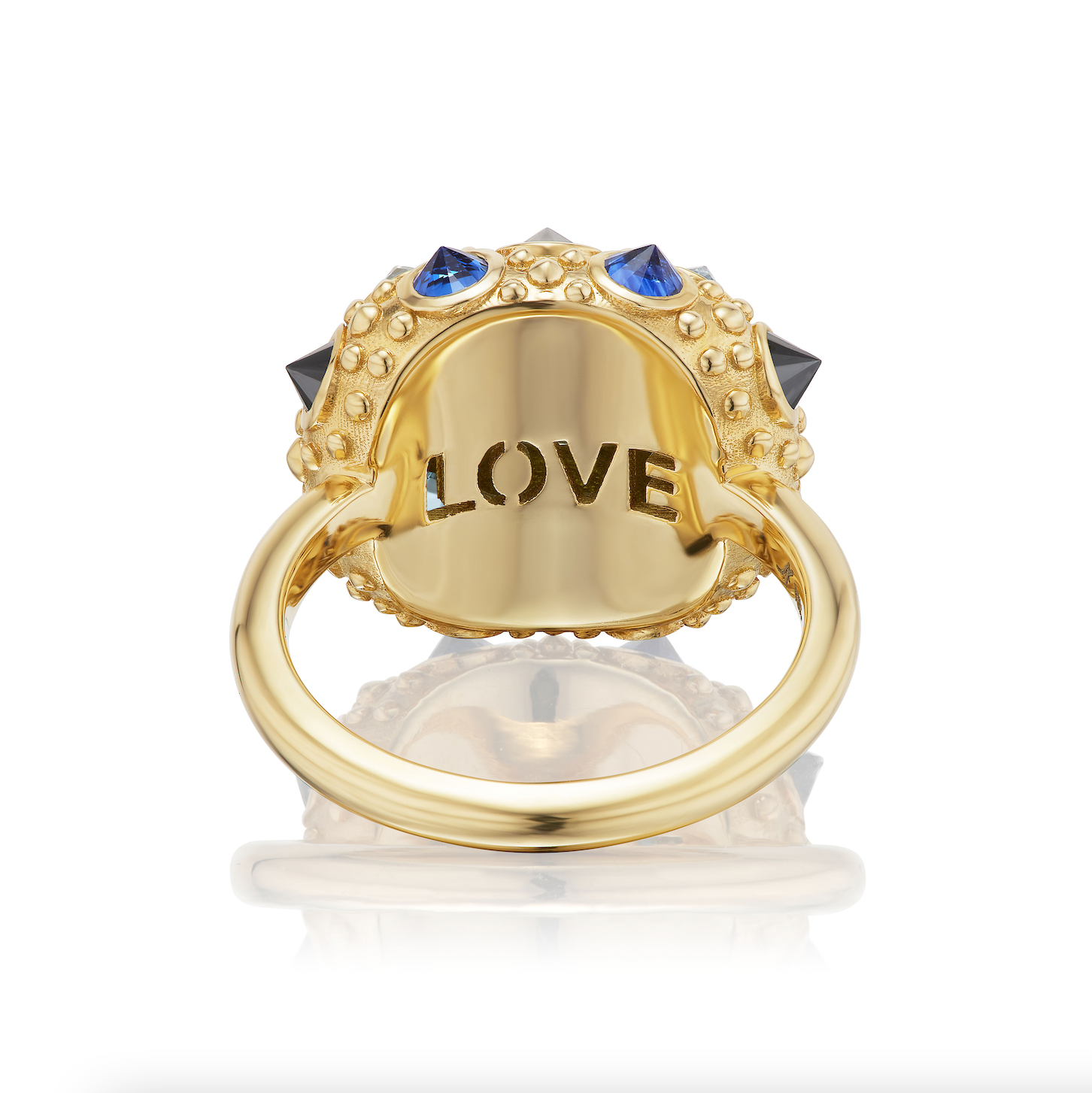 The underside view of this stunning ring crafted in 18k yellow gold, adorned with 1.18ct Apatite, .44ct Aqua, .73ct Blue Sapphire, and .75ct Black Diamond, featuring an exquisite design inspired by the delicate sea urchin. Engraved with 'LOVE' underneath.