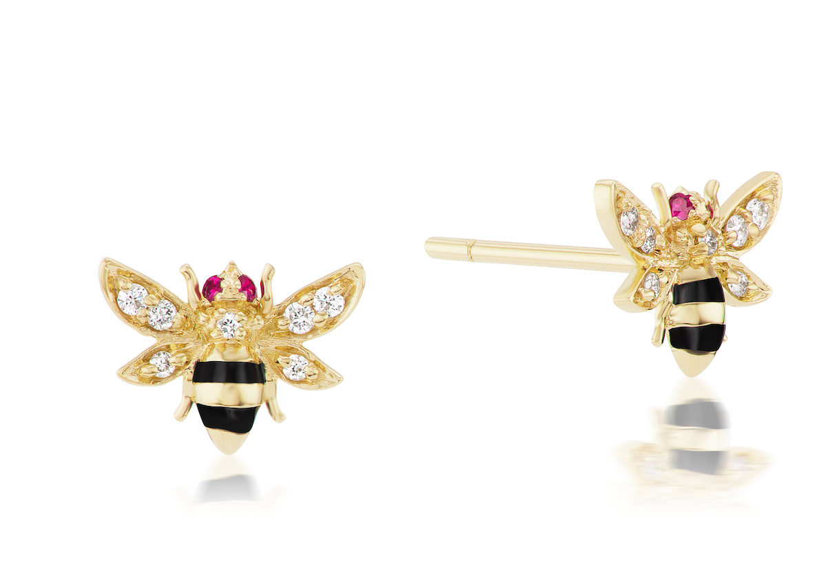 A side view of 18k yellow gold Bumble Bee stud earrings with ruby eyes, diamond wings, and black enamel stripes.