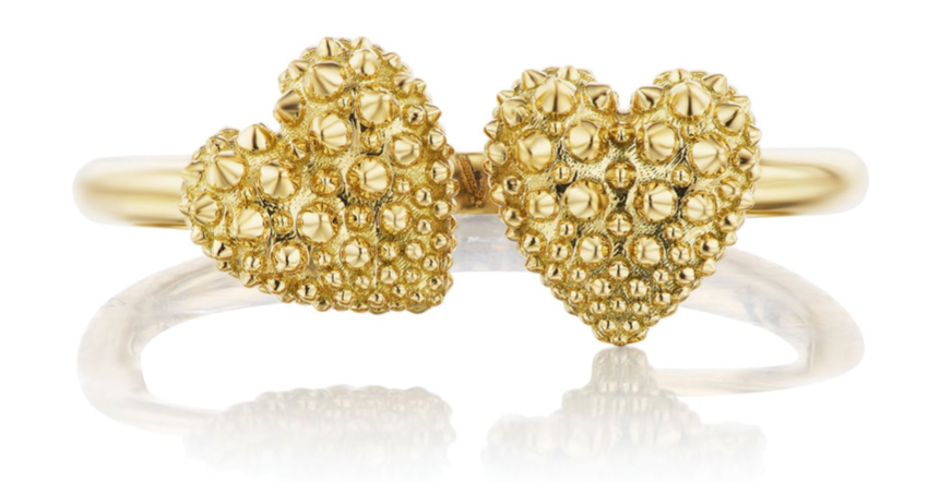A closeup, top-down view of an 18k yellow gold ring with two spiked hearts side by side for a new spin on the classic 'moi et toi' design by Ana-Katarina fine jewelry. 